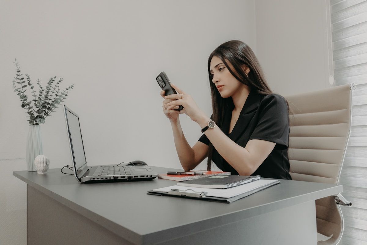 A professional taking a phone call at an office desk