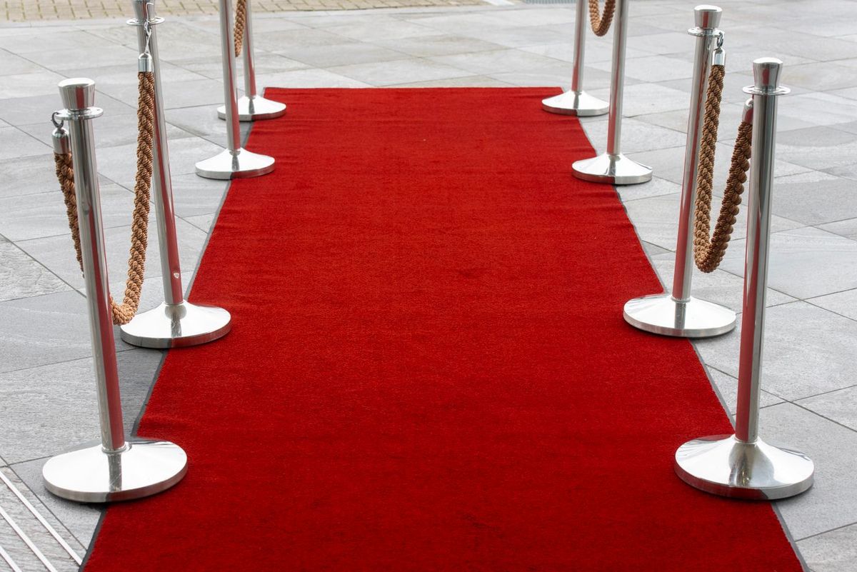 Stanchions and rope marking a managed entry lane at a venue